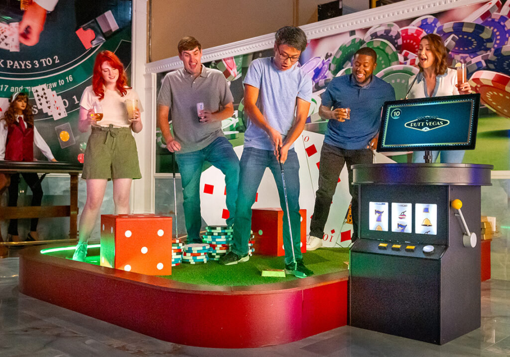 friends playing putt putt at a group event